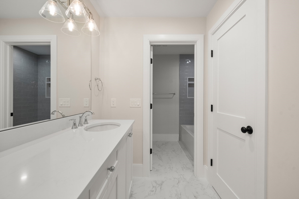 16 Wayside Road, Unit 14 Natick, MA 01760 - Photo 29 of 42 a bathroom with a sink a toilet and shower