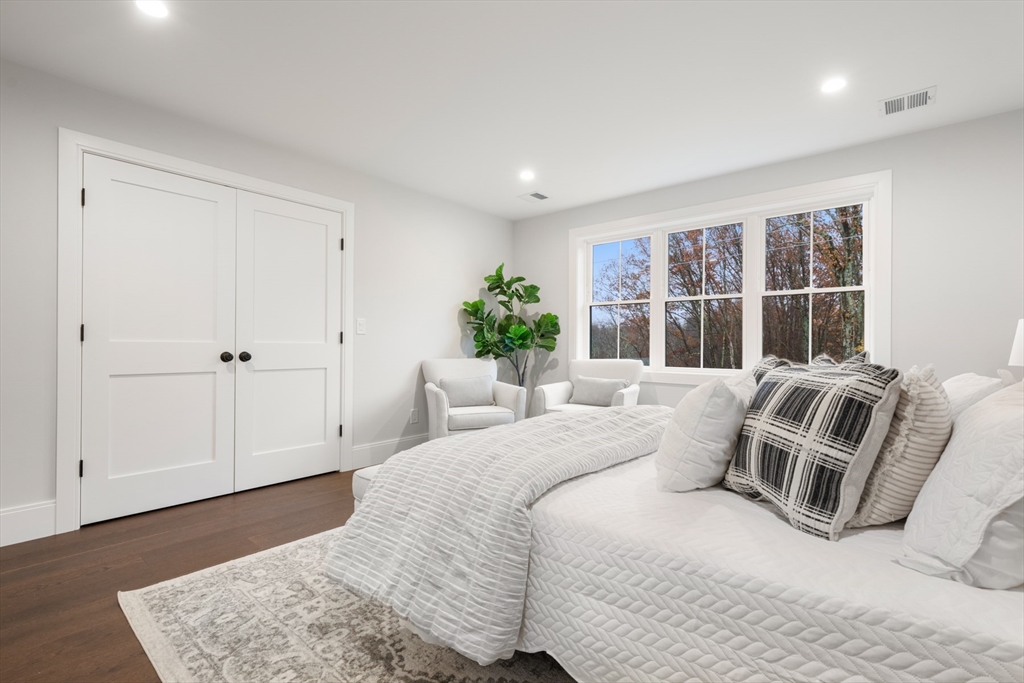 16 Wayside Road, Unit 14 Natick, MA 01760 - Photo 32 of 42 a bedroom with a bed and wooden floor