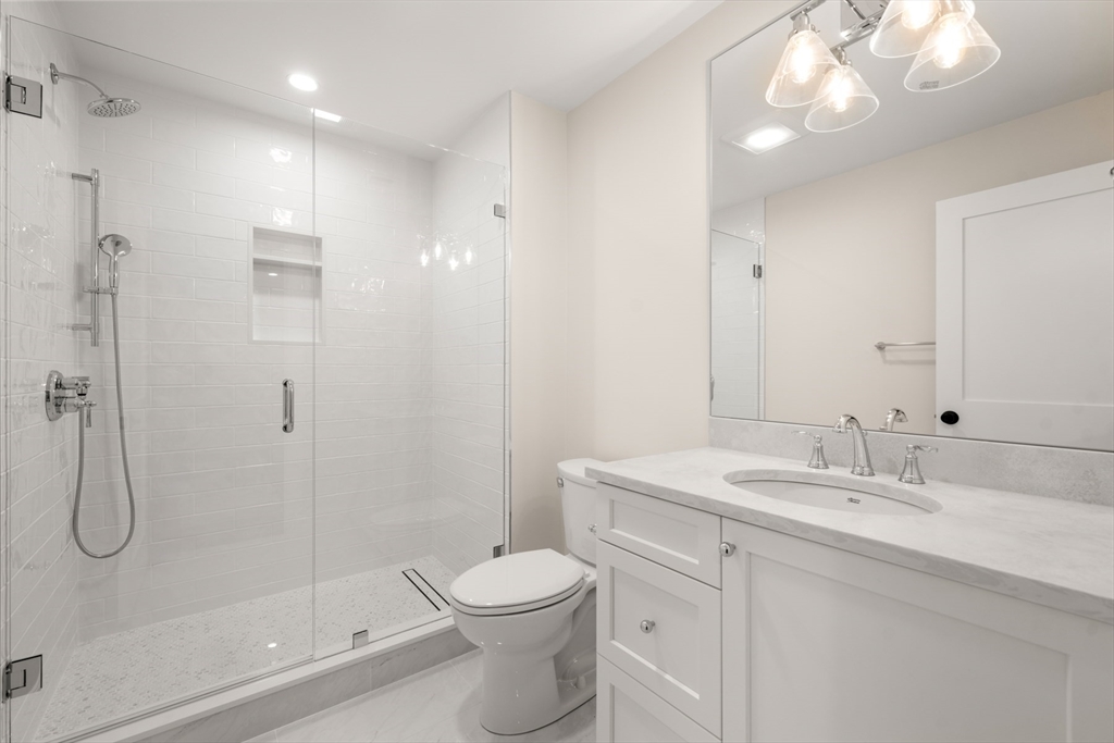 16 Wayside Road, Unit 14 Natick, MA 01760 - Photo 33 of 42 a bathroom with a sink a toilet and shower