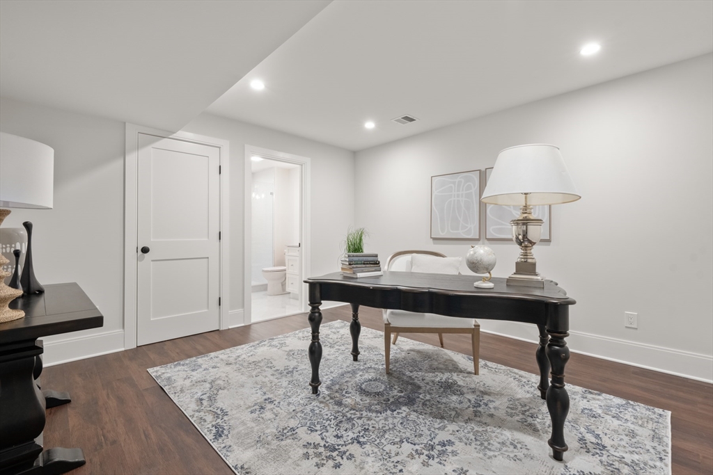 16 Wayside Road, Unit 14 Natick, MA 01760 - Photo 34 of 42 a view of a room that has a table and chairs in it