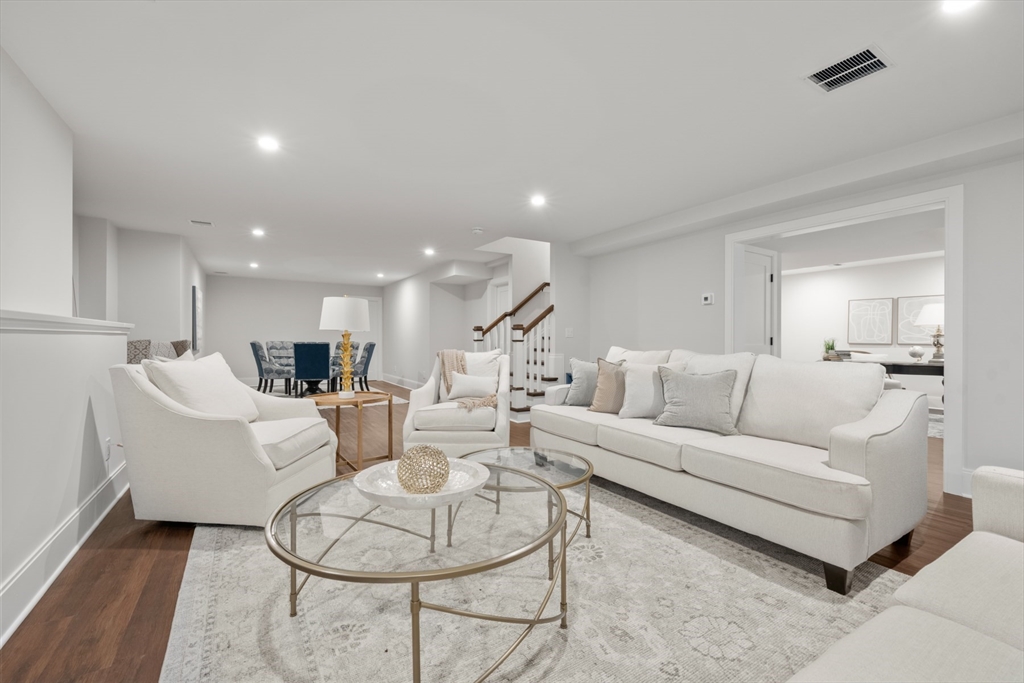 16 Wayside Road, Unit 14 Natick, MA 01760 - Photo 40 of 42 a living room with furniture kitchen view and a wooden floor