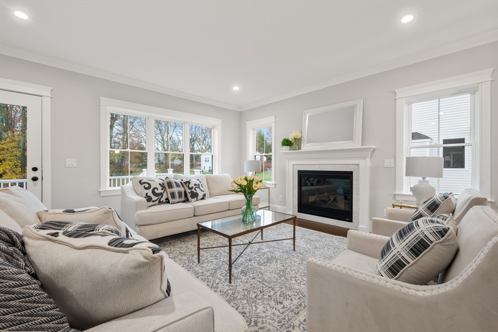 16 Wayside Road, Unit 14 Natick, MA 01760 - Photo 10 of 42 a living room with furniture a fireplace and a floor to ceiling window