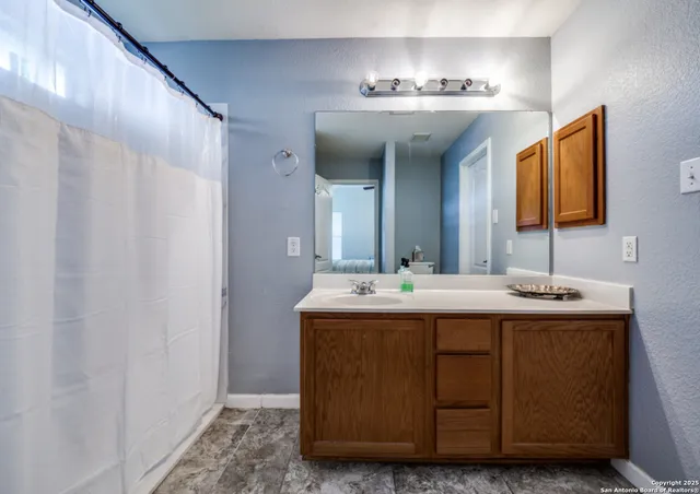 a bathroom with a double vanity sink and a mirror
