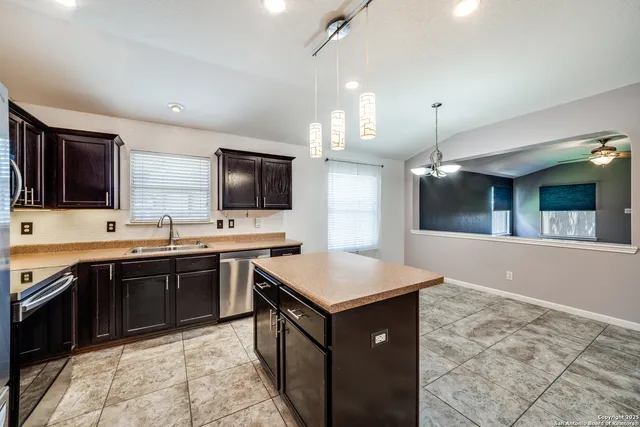 a kitchen with a sink stove and microwave