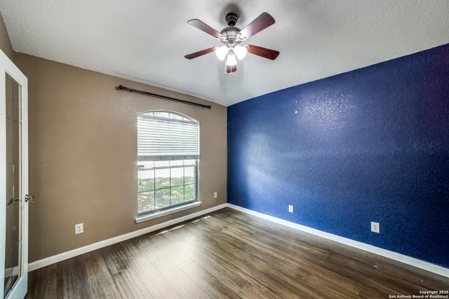 wooden floor in an empty room with a window