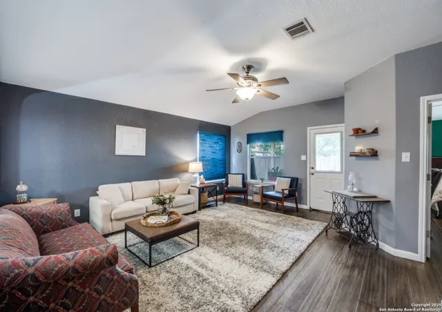 a living room with furniture and wooden floor