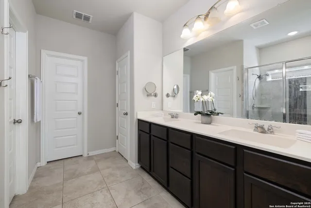 a bathroom with a double vanity sink mirror and double