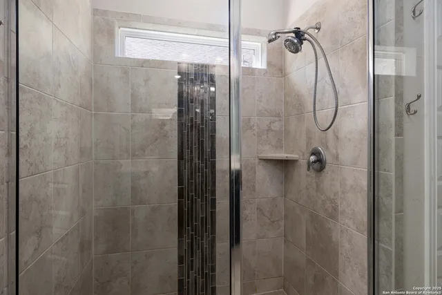 a bathroom with a glass shower door