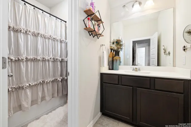 a bathroom with a sink vanity and a mirror