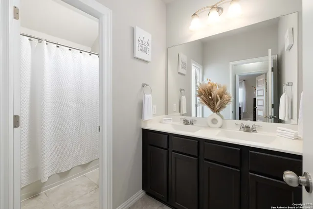 a bathroom with a double vanity sink and mirror