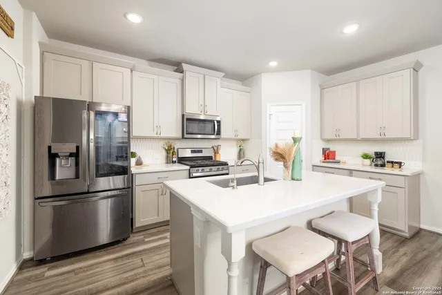 a kitchen with stainless steel appliances a refrigerator stove microwave and cabinets