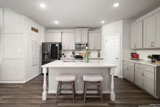 a kitchen with refrigerator cabinets and wooden floor