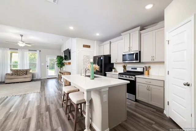a kitchen with cabinets and stainless steel appliances
