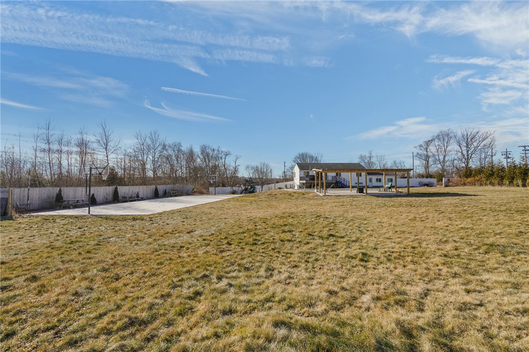 1275 Seven Mile Road Cranston, RI 02831 - Photo 38 of 41 Basketball court and rear yard with outdoor entertainment space