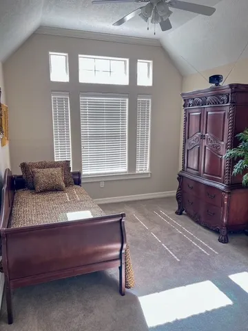 a bedroom with bed and a window