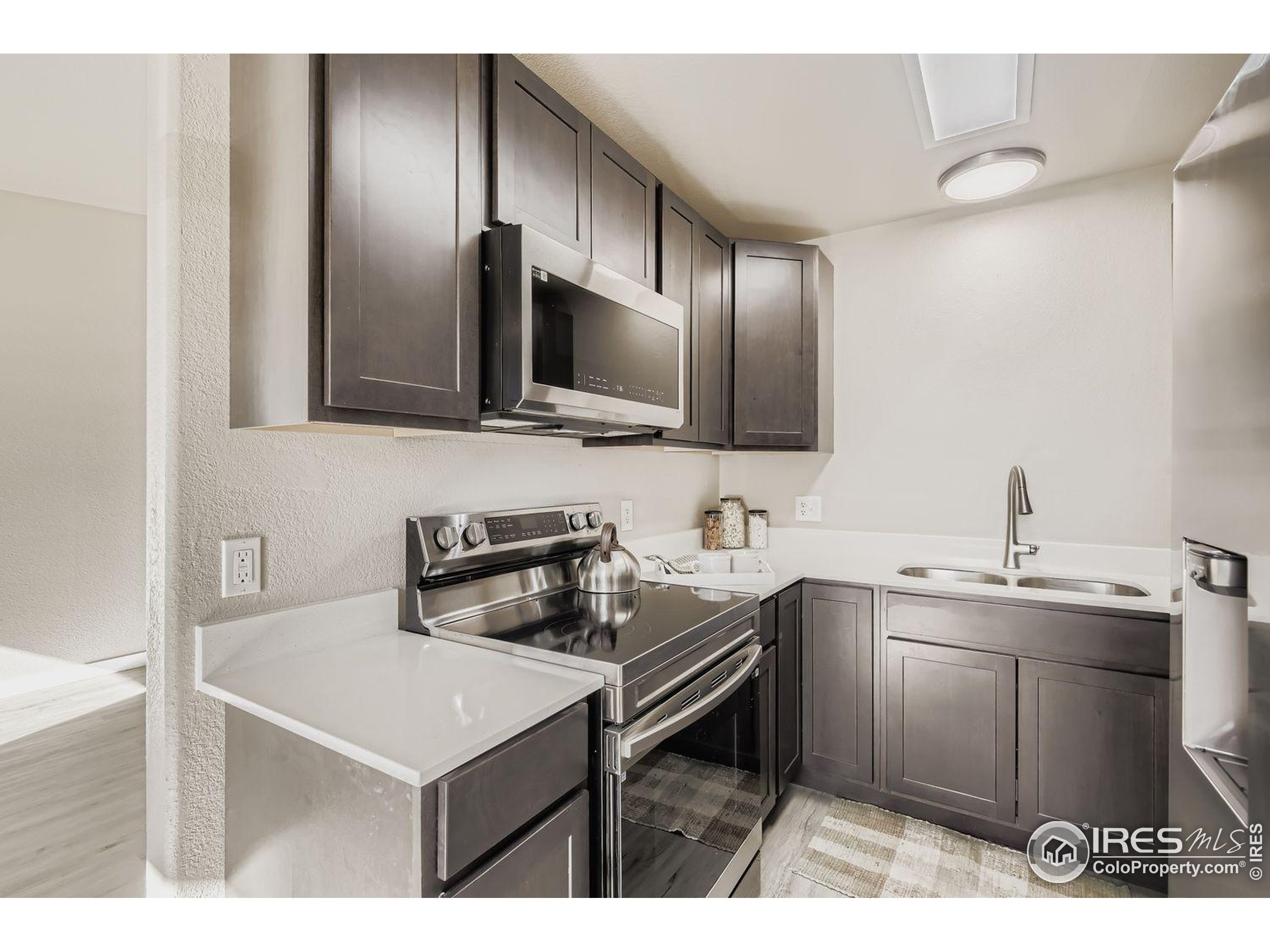 a kitchen with a sink cabinets and stainless steel appliances