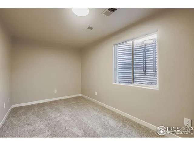 a view of a hallway with closet and mirror