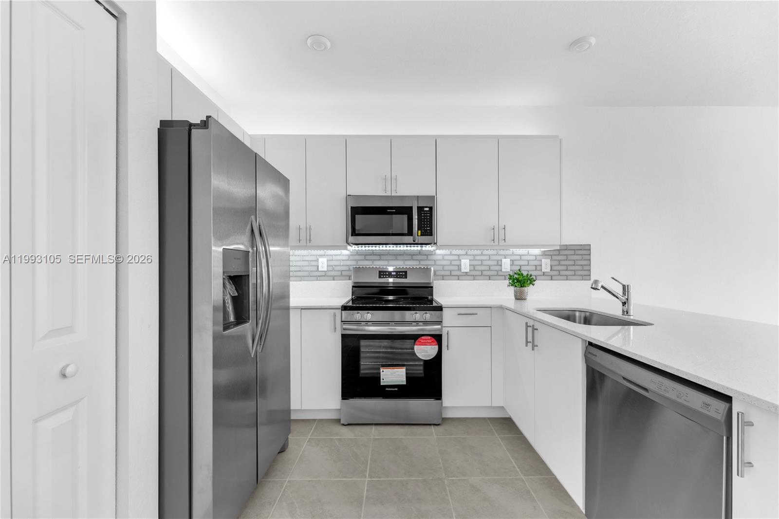 2425 Southeast 28th Drive, Unit 2425 Homestead, FL 33035 - Photo 21 of 98 a kitchen with a sink and stainless steel appliances