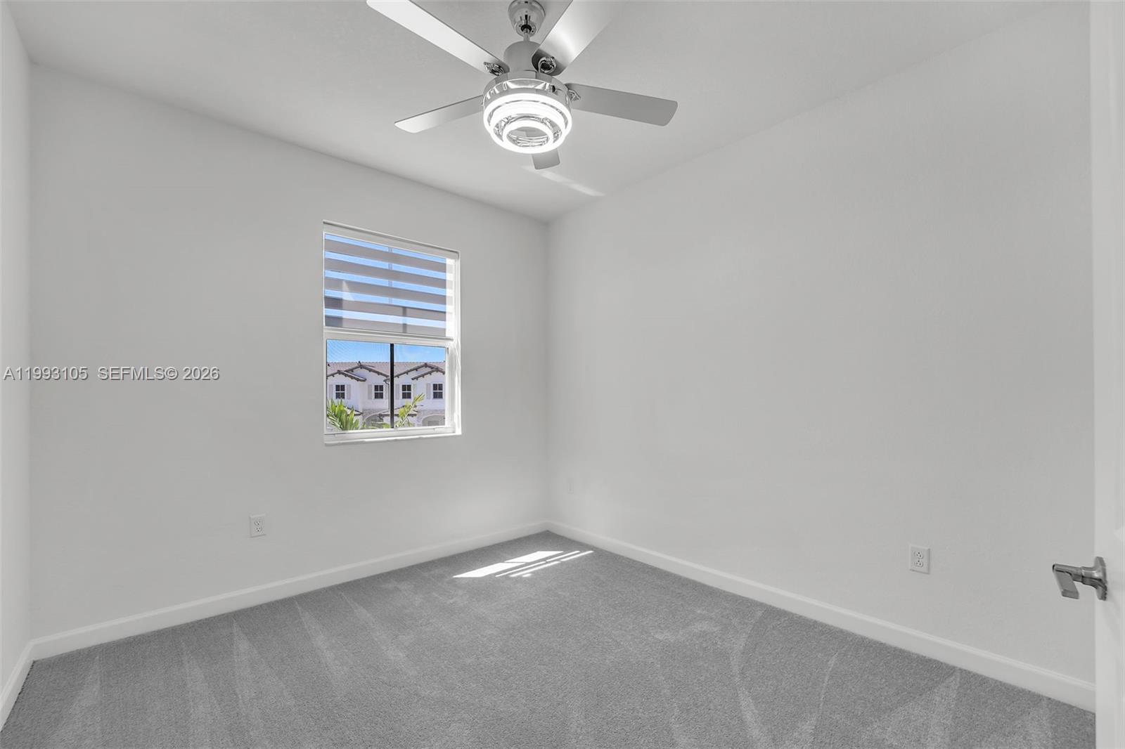 2425 Southeast 28th Drive, Unit 2425 Homestead, FL 33035 - Photo 28 of 98 an empty room with windows and fan