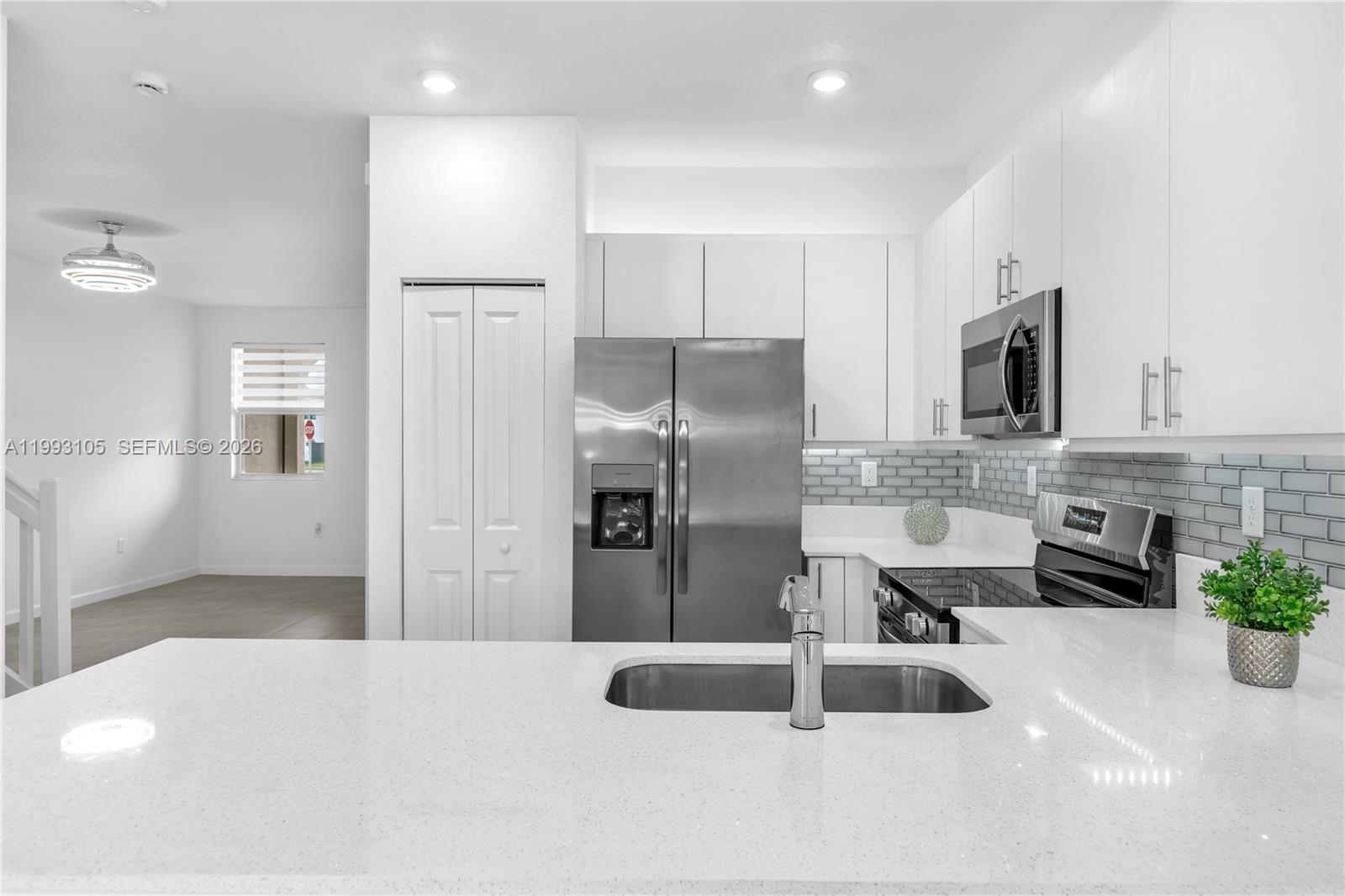 2425 Southeast 28th Drive, Unit 2425 Homestead, FL 33035 - Photo 32 of 98 a kitchen with stainless steel appliances a sink refrigerator and microwave