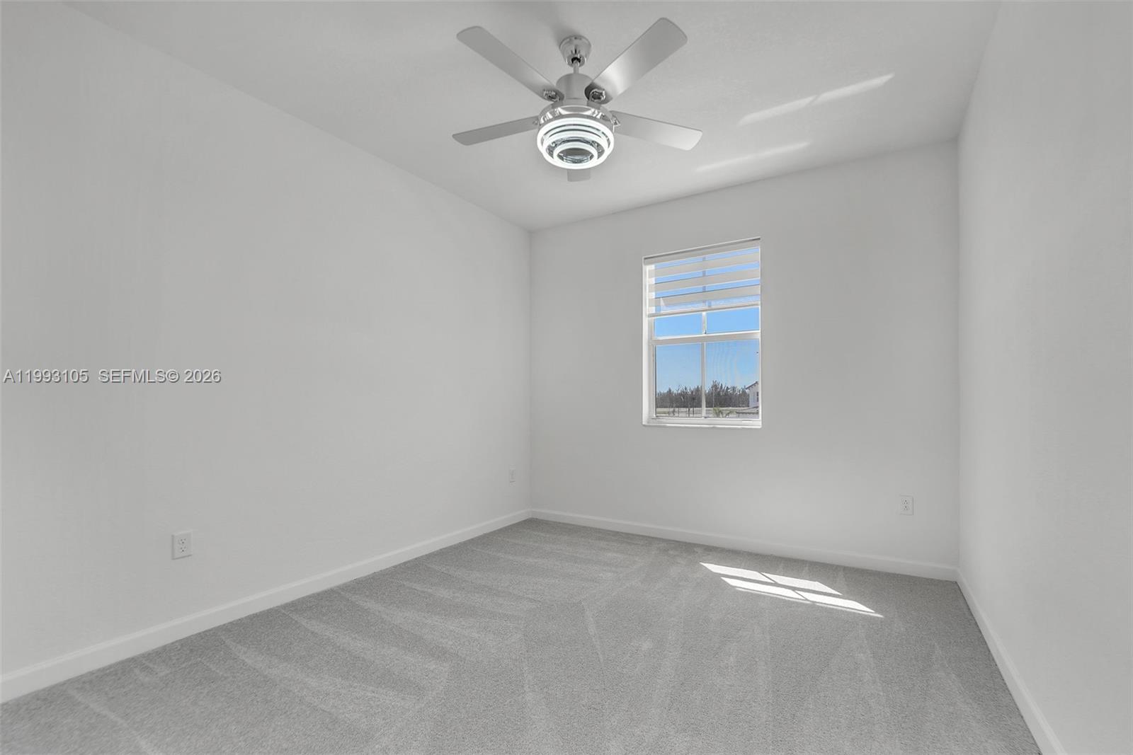 2425 Southeast 28th Drive, Unit 2425 Homestead, FL 33035 - Photo 36 of 98 an empty room with windows and ceiling fan
