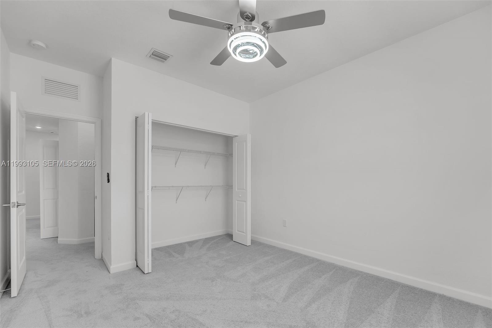 2425 Southeast 28th Drive, Unit 2425 Homestead, FL 33035 - Photo 38 of 98 an empty room with closet and a ceiling fan