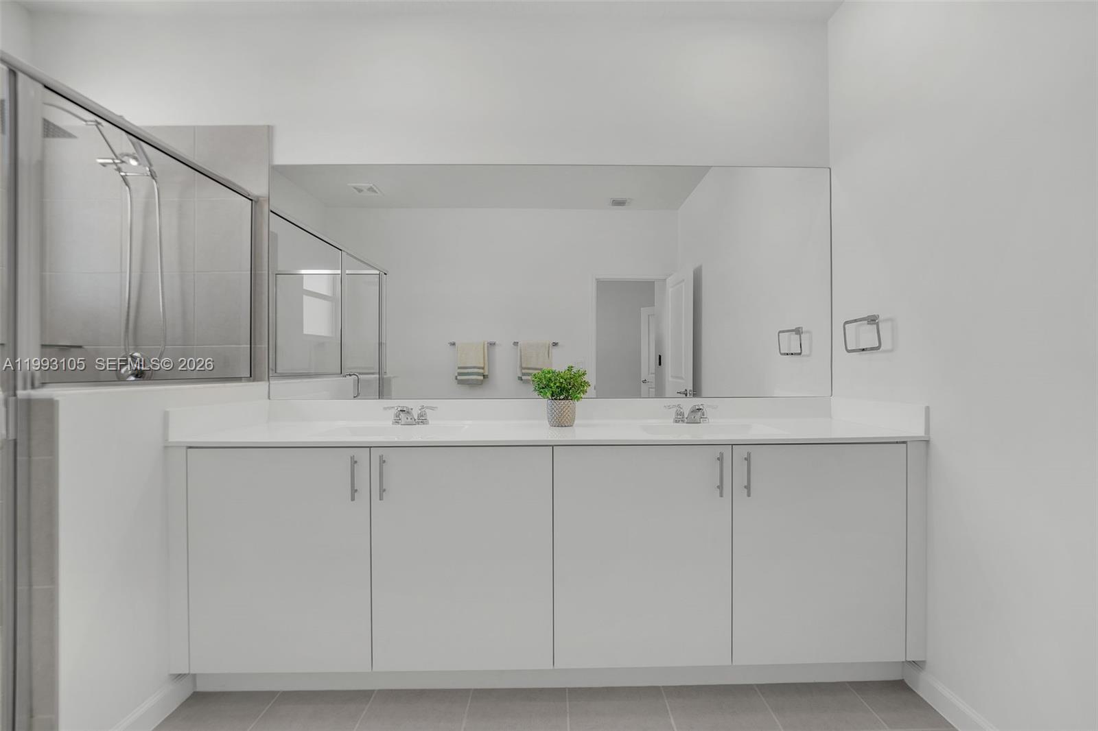 2425 Southeast 28th Drive, Unit 2425 Homestead, FL 33035 - Photo 49 of 98 a bathroom with a sink and a mirror