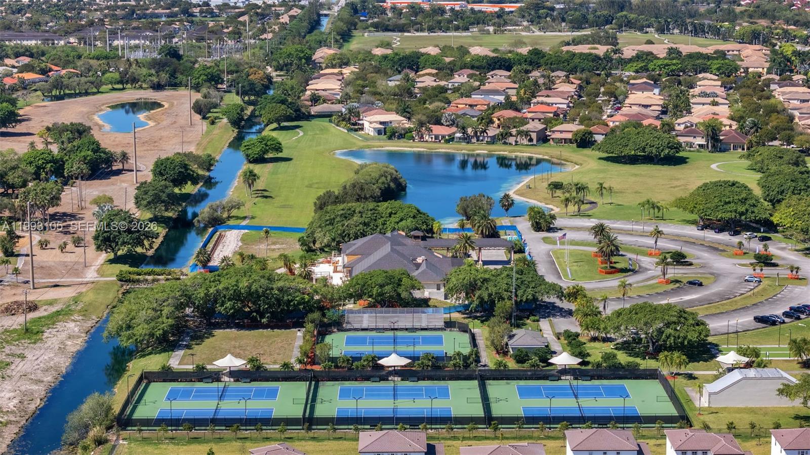 2425 Southeast 28th Drive, Unit 2425 Homestead, FL 33035 - Photo 68 of 98 an aerial view of residential houses with outdoor space and lake view