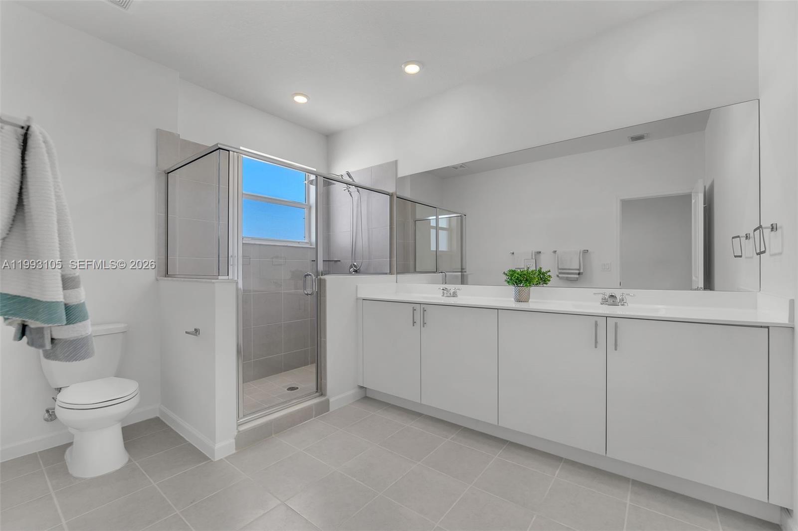 2425 Southeast 28th Drive, Unit 2425 Homestead, FL 33035 - Photo 7 of 98 a bathroom with a double vanity sink toilet and shower