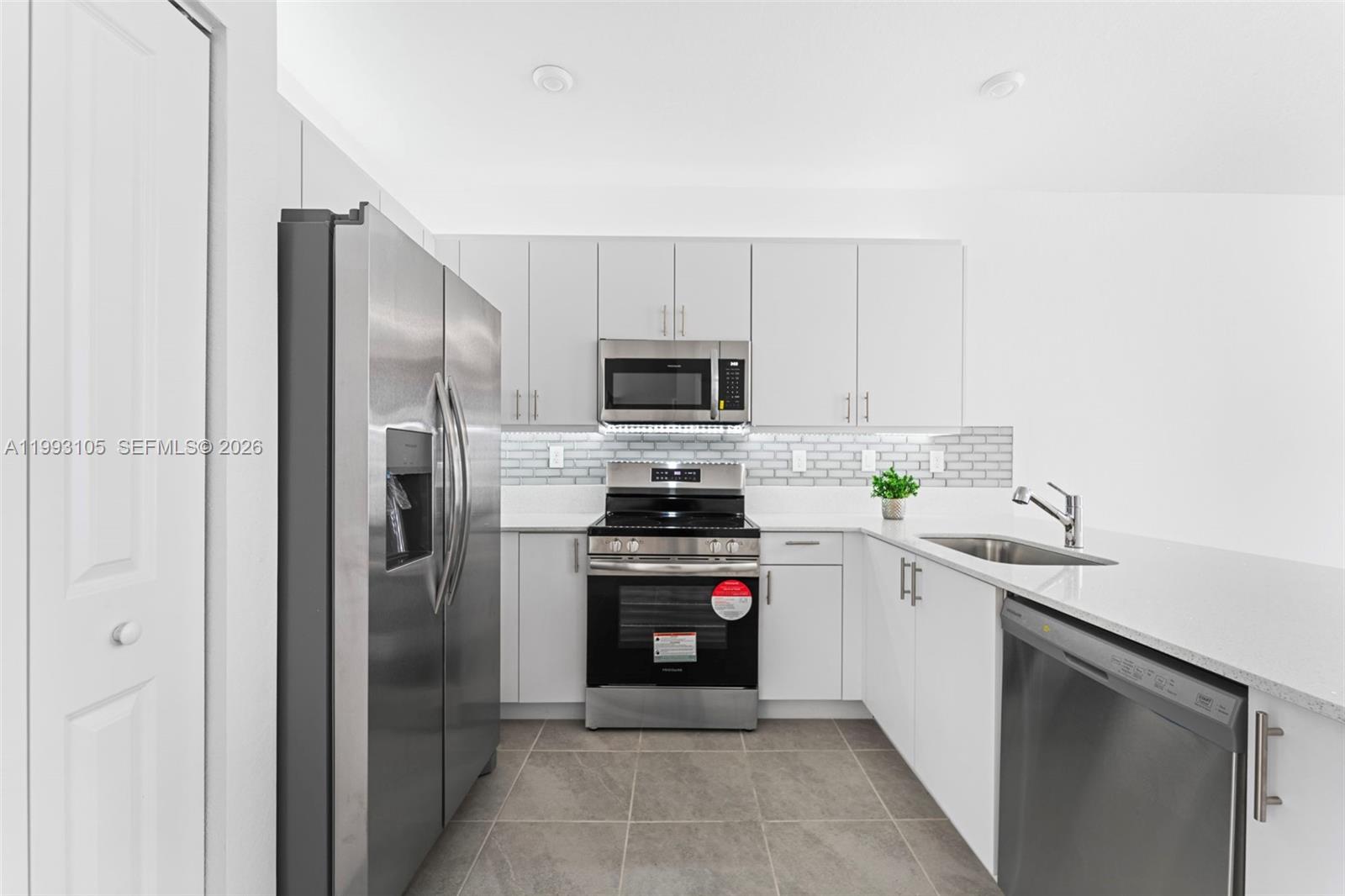 2425 Southeast 28th Drive, Unit 2425 Homestead, FL 33035 - Photo 95 of 98 a kitchen with a sink and stainless steel appliances