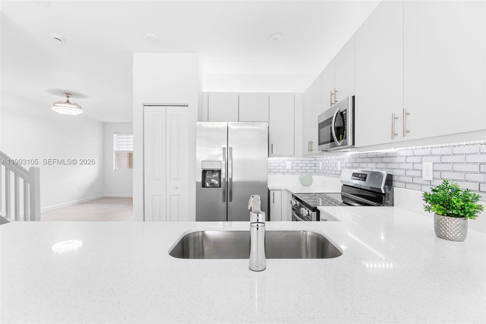 2425 Southeast 28th Drive, Unit 2425 Homestead, FL 33035 - Photo 98 of 98 a kitchen with stainless steel appliances a sink a refrigerator a microwave a sink and cabinets