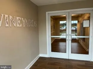 a view of a hallway with wooden floor and dining room