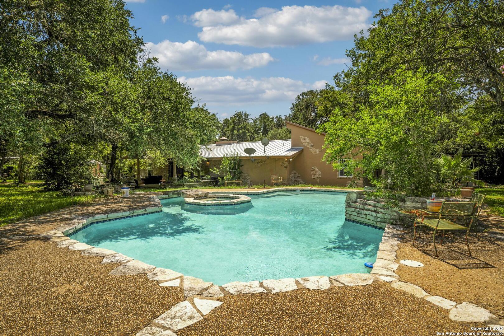 a view of a swimming pool with a yard