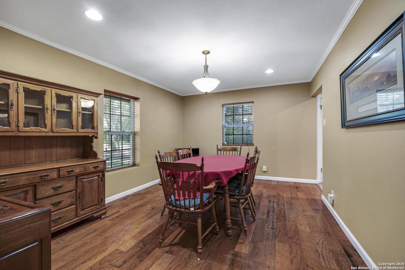 10855 Jericho Road Helotes, TX 78023 - Photo 20 of 59 a view of a dining room with furniture window and wooden floor