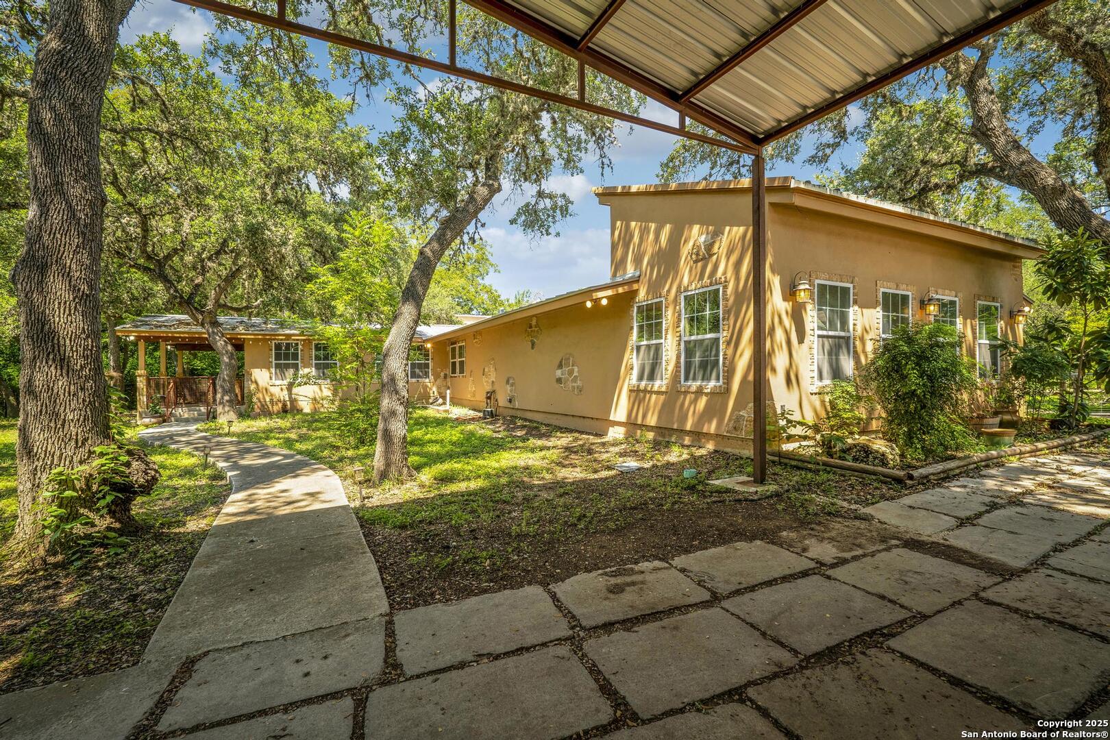 10855 Jericho Road Helotes, TX 78023 - Photo 2 of 59 a view of a house with backyard and garden