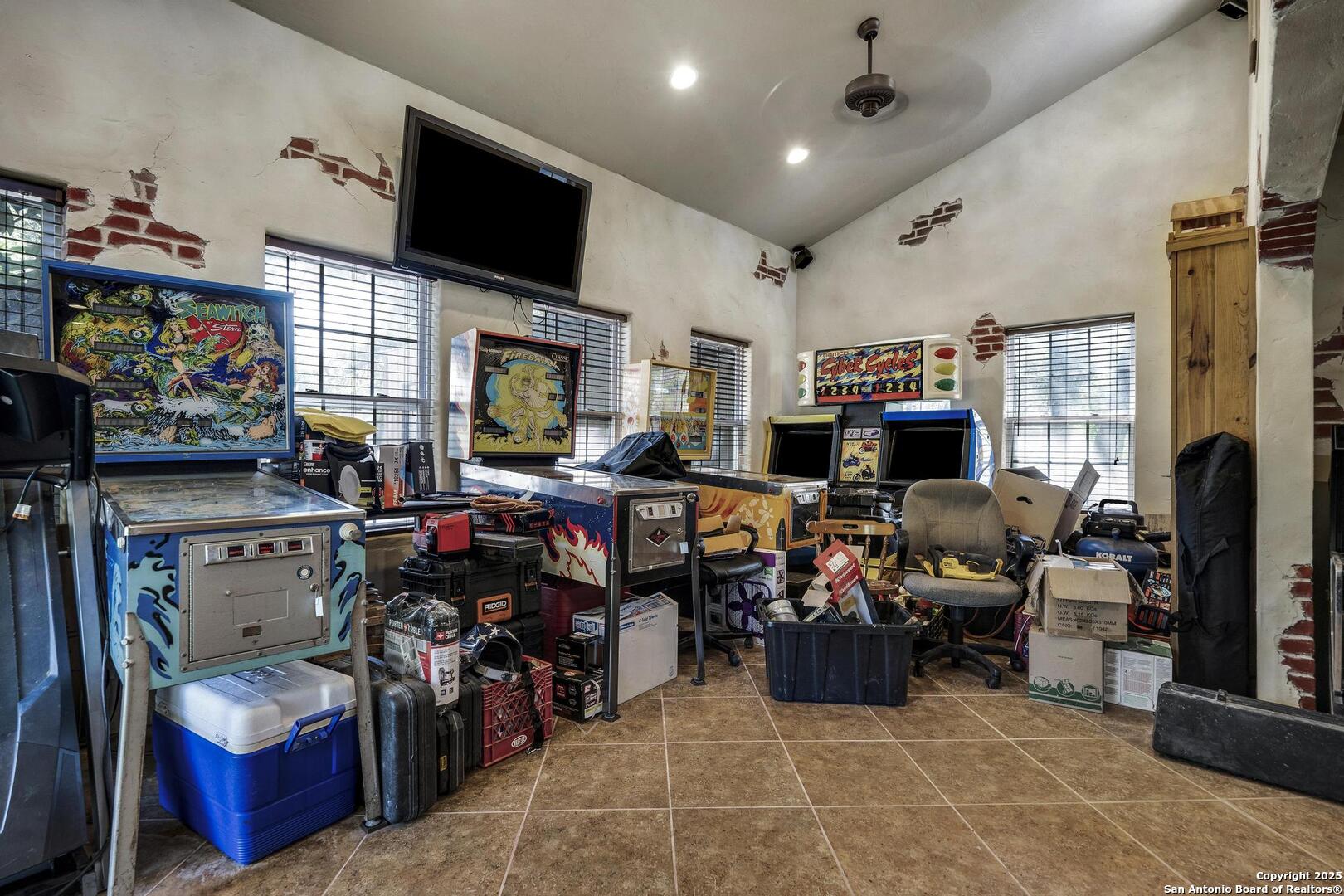 10855 Jericho Road Helotes, TX 78023 - Photo 27 of 59 a living room with lots of furniture and a flat screen tv