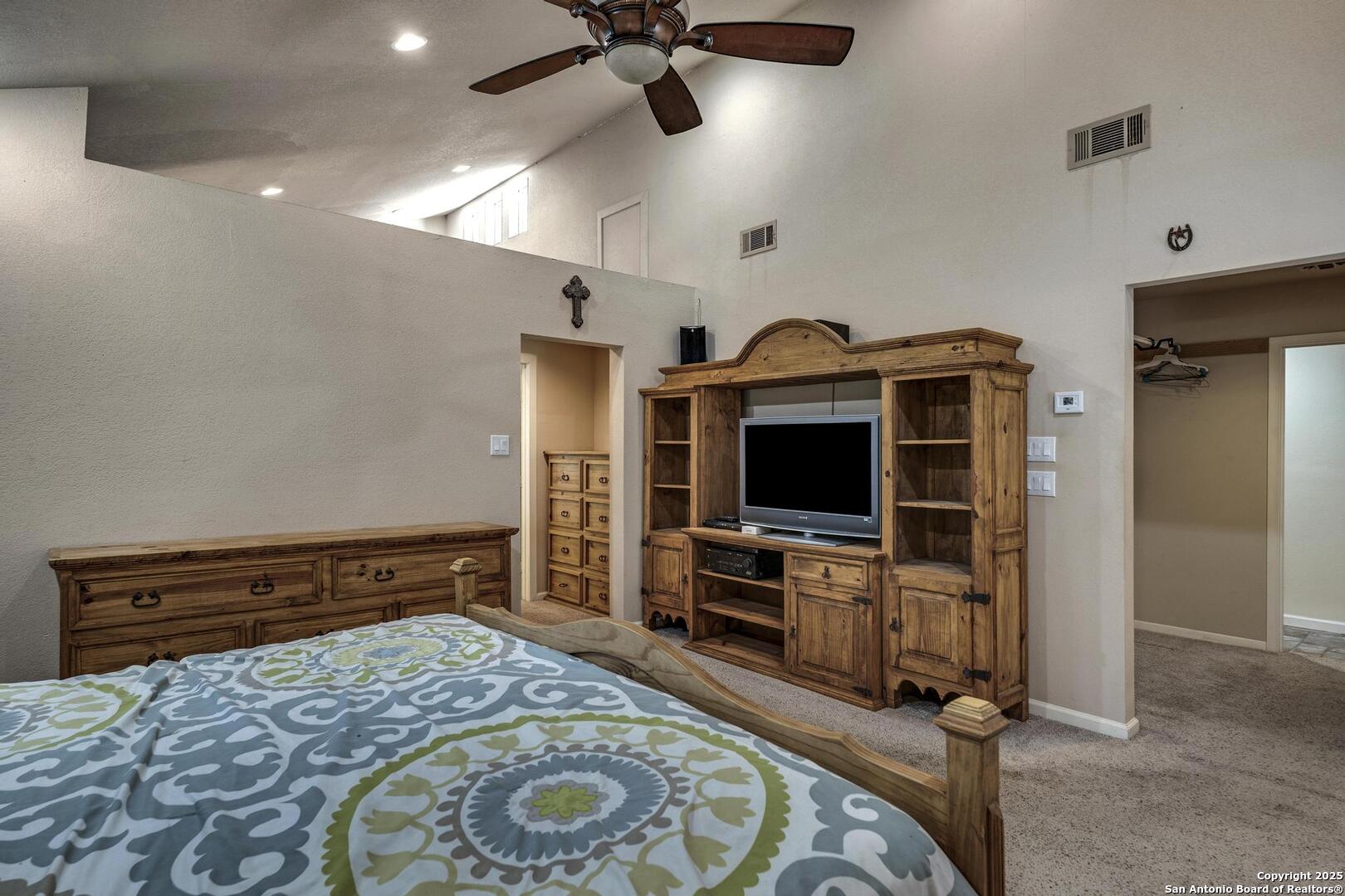 10855 Jericho Road Helotes, TX 78023 - Photo 34 of 59 a bedroom with furniture and flat screen tv