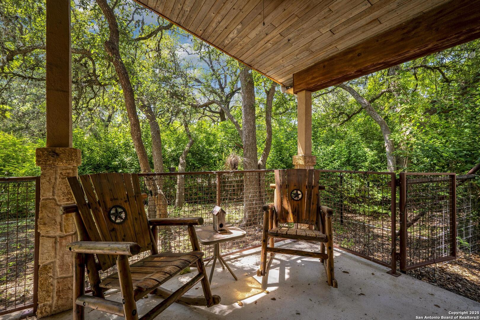 10855 Jericho Road Helotes, TX 78023 - Photo 45 of 59 a view of a chairs and table in the patio
