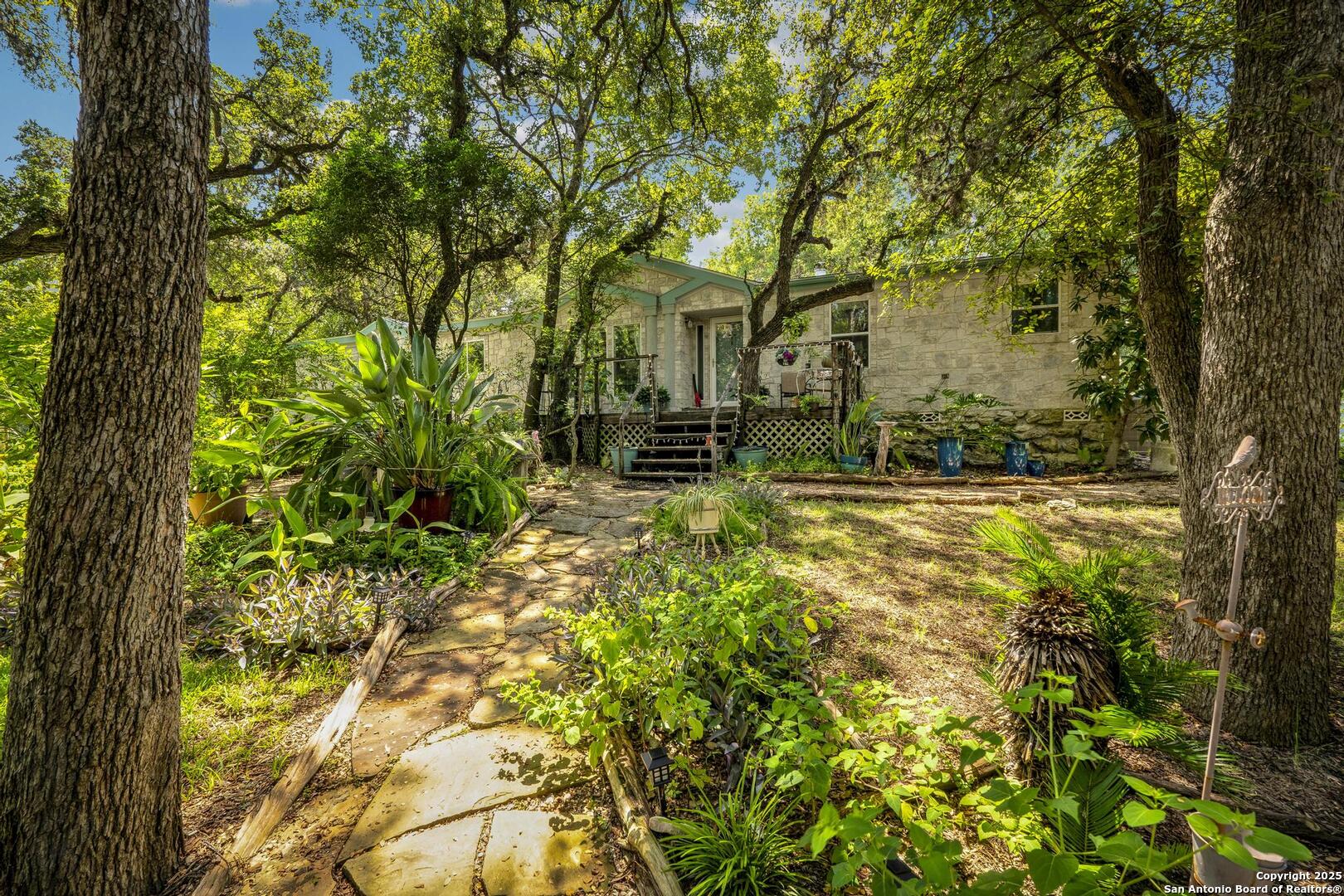 10855 Jericho Road Helotes, TX 78023 - Photo 46 of 59 a backyard of a house with table and chairs