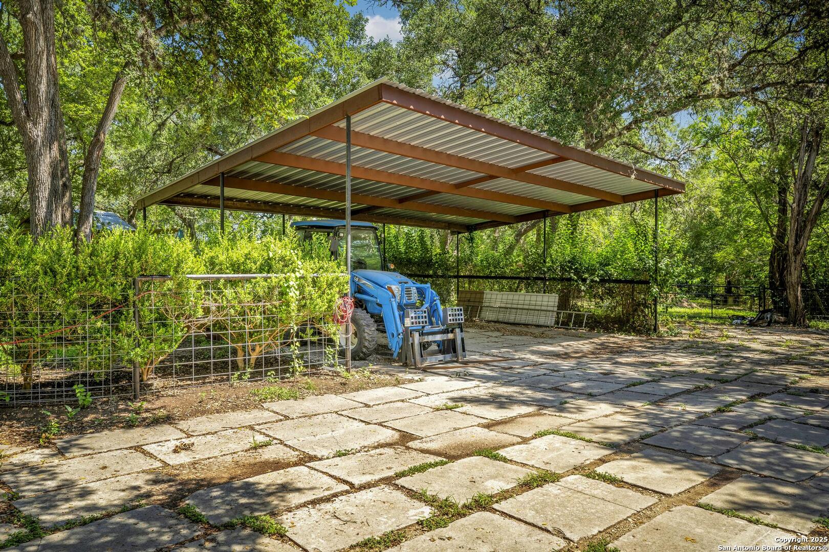 10855 Jericho Road Helotes, TX 78023 - Photo 50 of 59 a patio with table and chairs under an umbrella