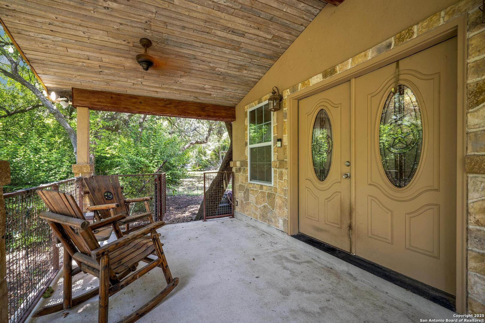 10855 Jericho Road Helotes, TX 78023 - Photo 5 of 59 a view of a porch with furniture and a gate