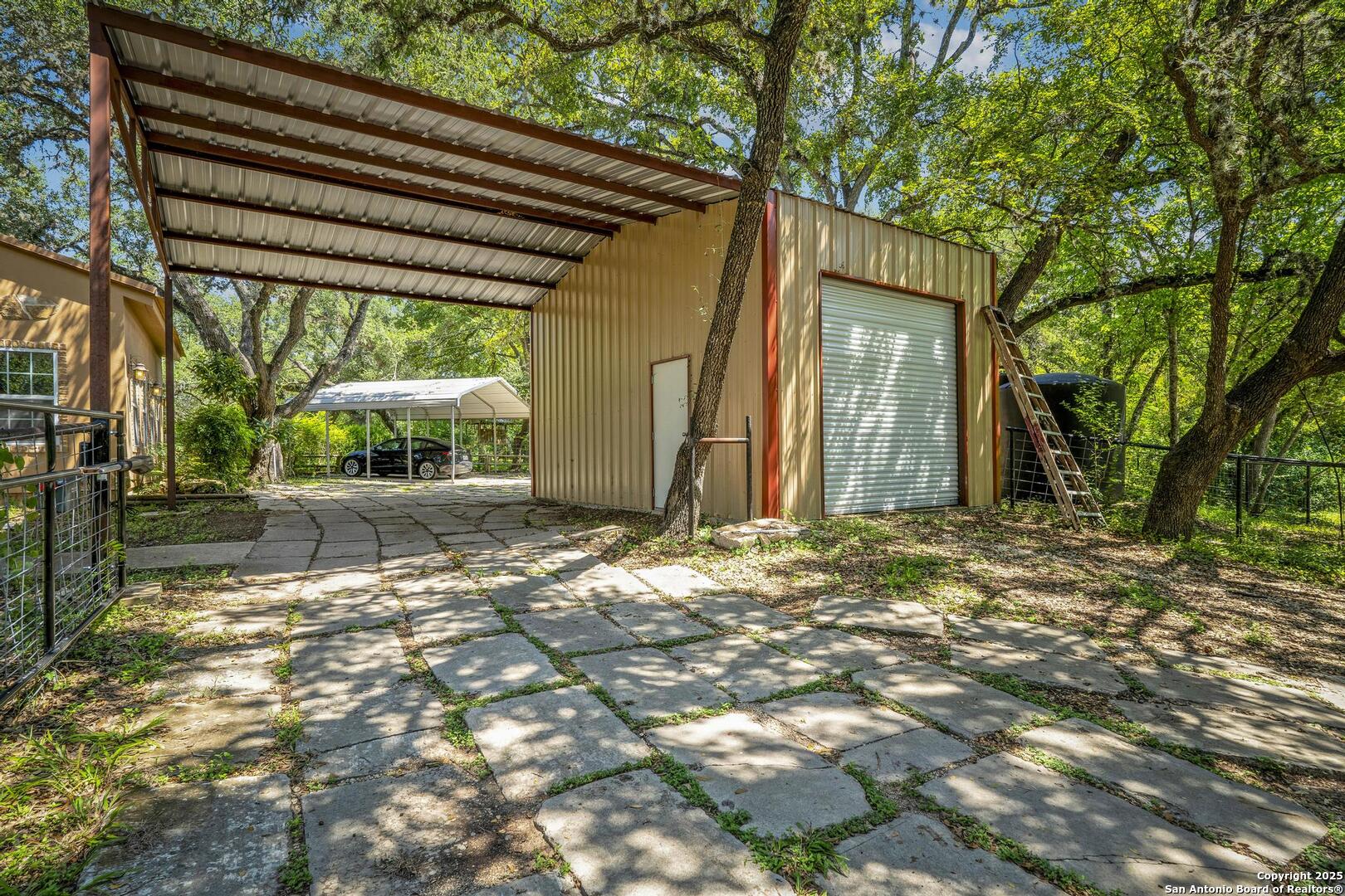 10855 Jericho Road Helotes, TX 78023 - Photo 52 of 59 a backyard of a house with table and chairs