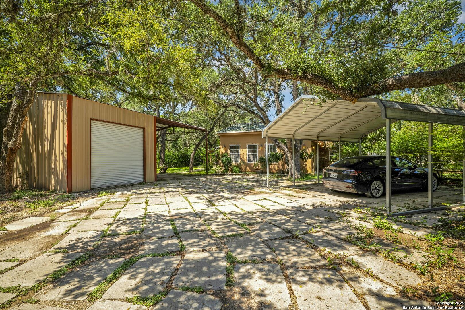 10855 Jericho Road Helotes, TX 78023 - Photo 53 of 59 a backyard of a house with yard and outdoor seating