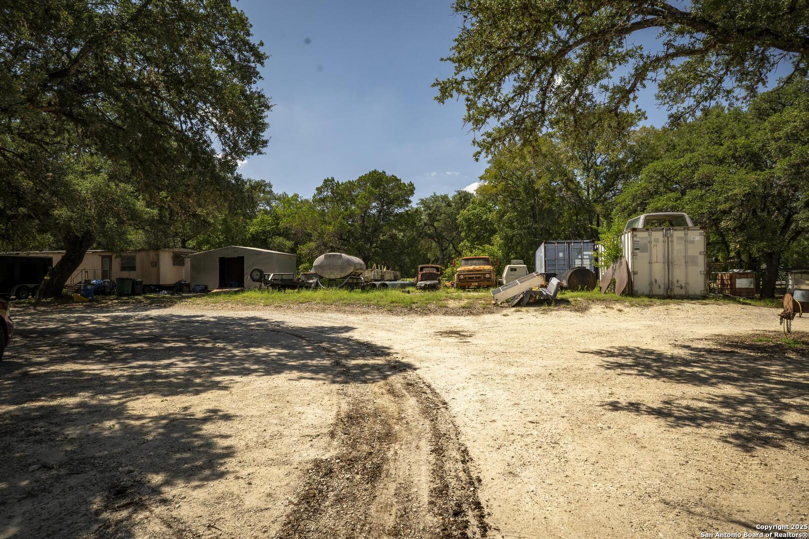 10855 Jericho Road Helotes, TX 78023 - Photo 54 of 59 a swimming pool with outdoor seating and yard