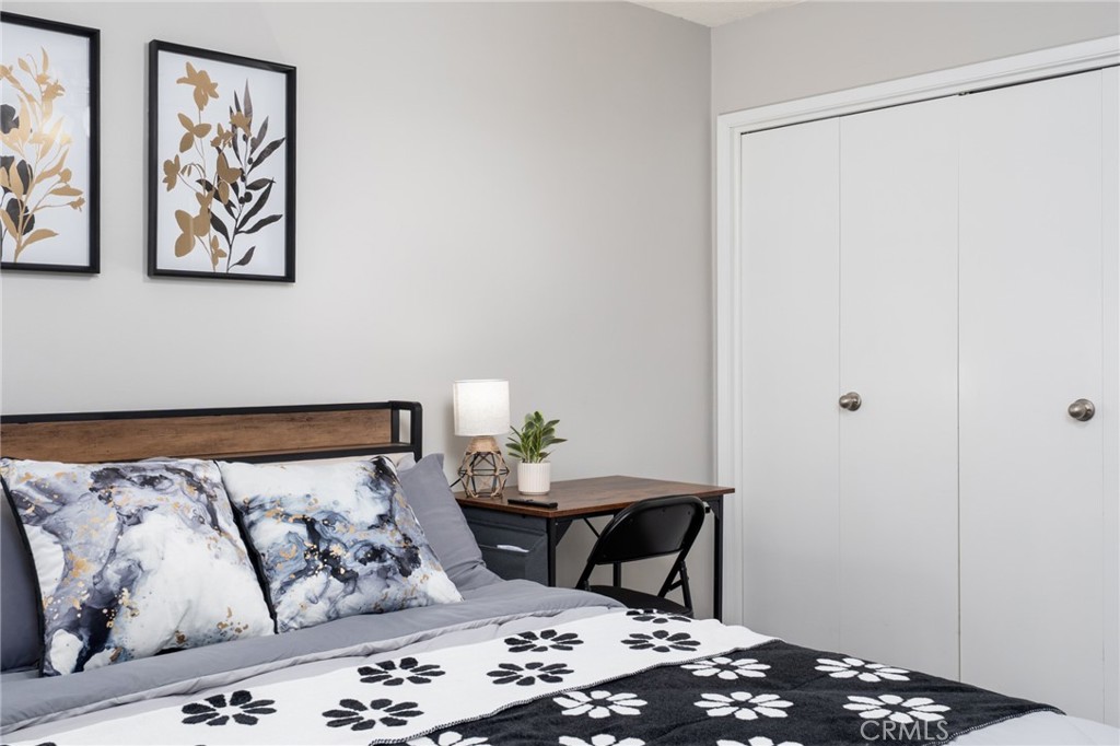 716 Orange Street Riverside, CA 92501 - Photo 22 of 28 a bedroom with a bed and painting on the wall