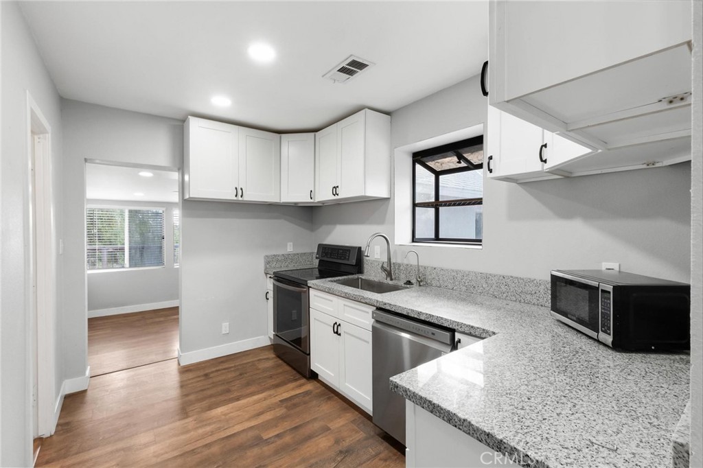 34789 Wildwood Canyon Road Yucaipa, CA 92399 - Photo 15 of 52 a kitchen with granite countertop a sink stainless steel appliances and cabinets