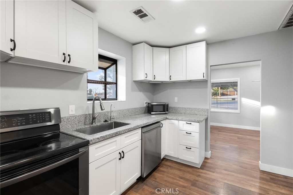 34789 Wildwood Canyon Road Yucaipa, CA 92399 - Photo 16 of 52 a kitchen with a sink stove and cabinets
