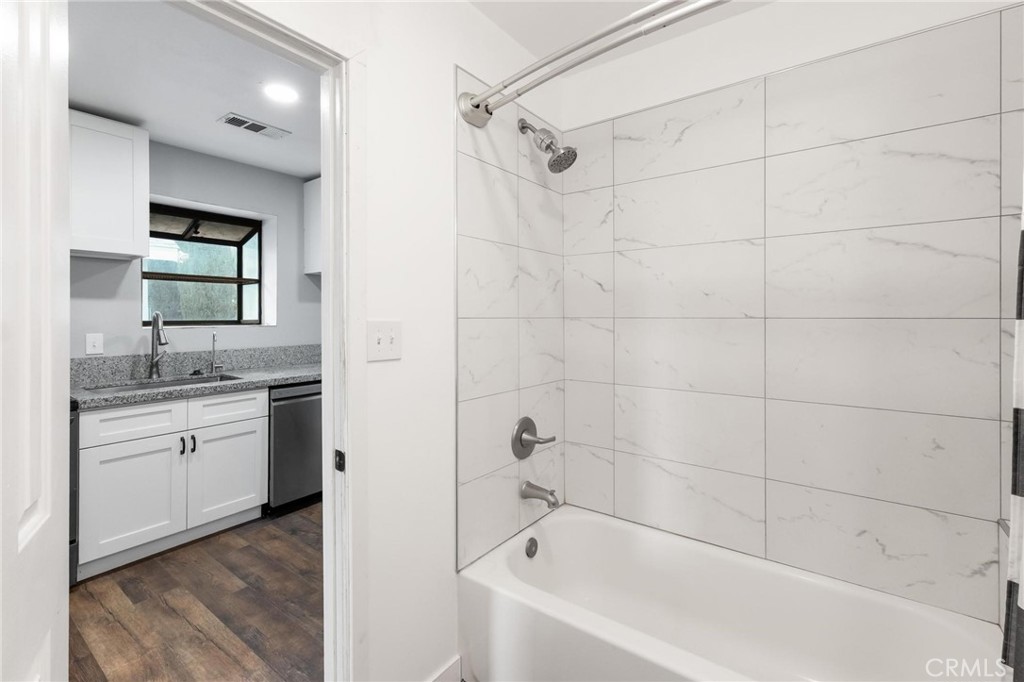 34789 Wildwood Canyon Road Yucaipa, CA 92399 - Photo 22 of 52 a bathroom with a granite countertop sink a toilet and bathtub