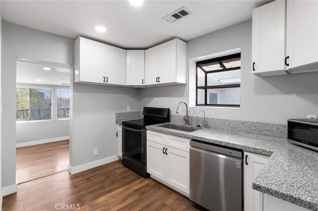 34789 Wildwood Canyon Road Yucaipa, CA 92399 - Photo 23 of 52 a kitchen with stainless steel appliances granite countertop a sink stove and cabinets