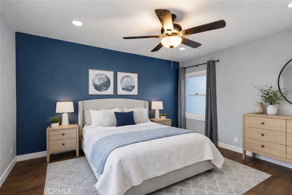 34789 Wildwood Canyon Road Yucaipa, CA 92399 - Photo 26 of 52 a bedroom with a large bed and a ceiling fan